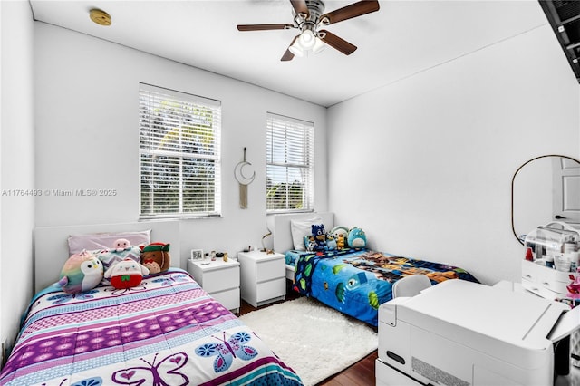 bedroom with ceiling fan and wood finished floors