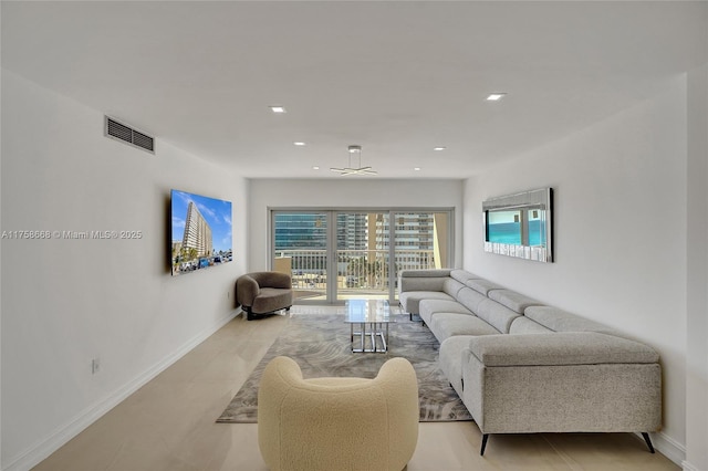 living area with recessed lighting, visible vents, and baseboards