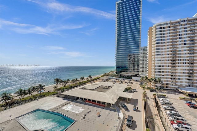 aerial view featuring a water view, a view of city, and a beach view