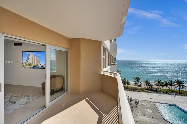 balcony with visible vents and a water view