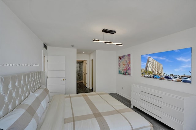 bedroom with dark wood-style floors, baseboards, and visible vents