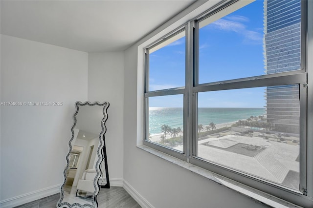 interior space featuring baseboards and a water view