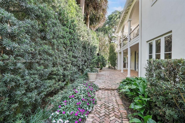 view of yard featuring a patio and a balcony