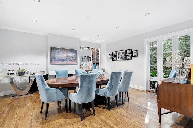 dining room featuring recessed lighting, light wood-type flooring, and baseboards