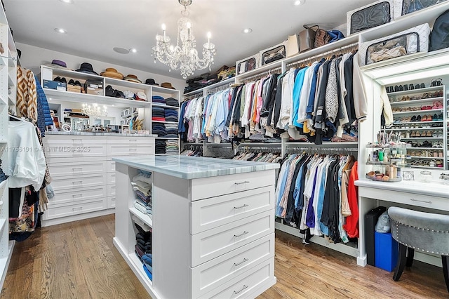 spacious closet featuring a chandelier and light wood finished floors