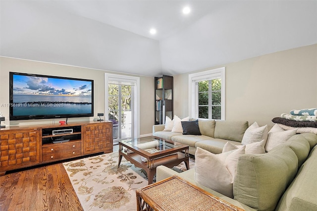 living room featuring vaulted ceiling, recessed lighting, and light wood-type flooring