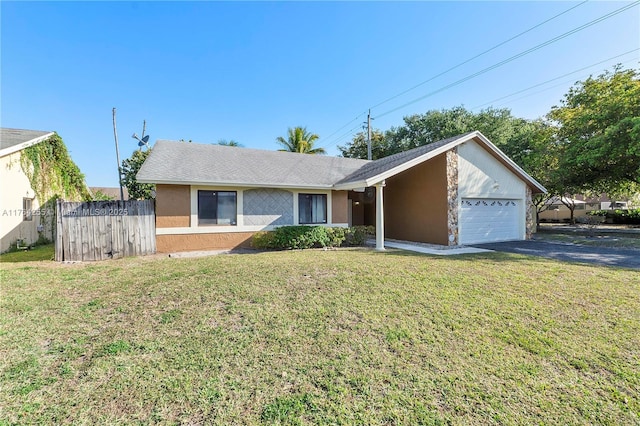 ranch-style house with a front yard, fence, driveway, an attached garage, and stucco siding