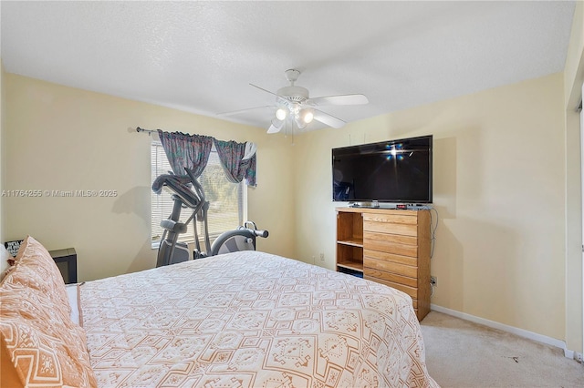 bedroom featuring a textured ceiling, a ceiling fan, baseboards, and carpet floors