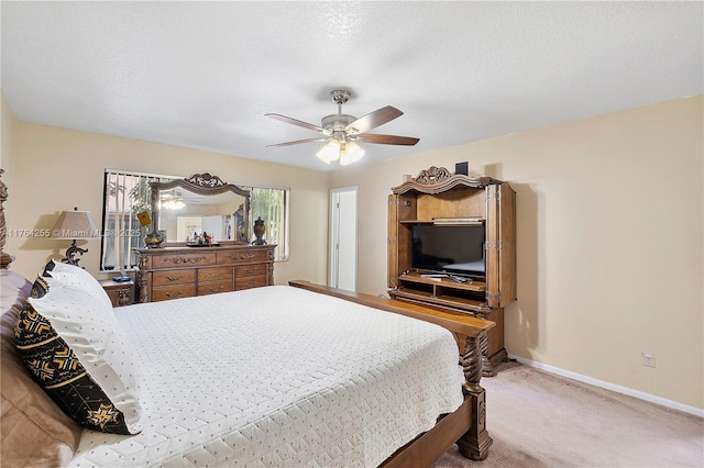 bedroom featuring ceiling fan, a textured ceiling, baseboards, and light carpet