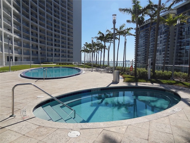 pool featuring a view of city and a patio area