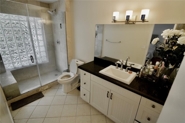 bathroom with vanity, a shower stall, toilet, and tile patterned floors