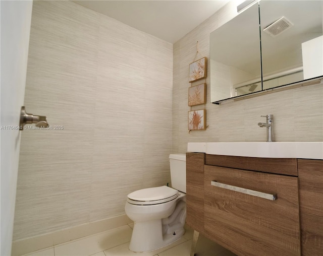 bathroom featuring visible vents, toilet, tile walls, tile patterned flooring, and vanity