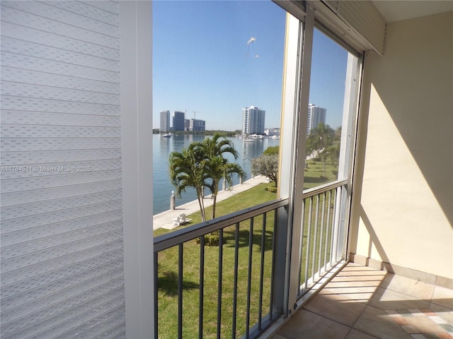 balcony featuring a view of city and a water view