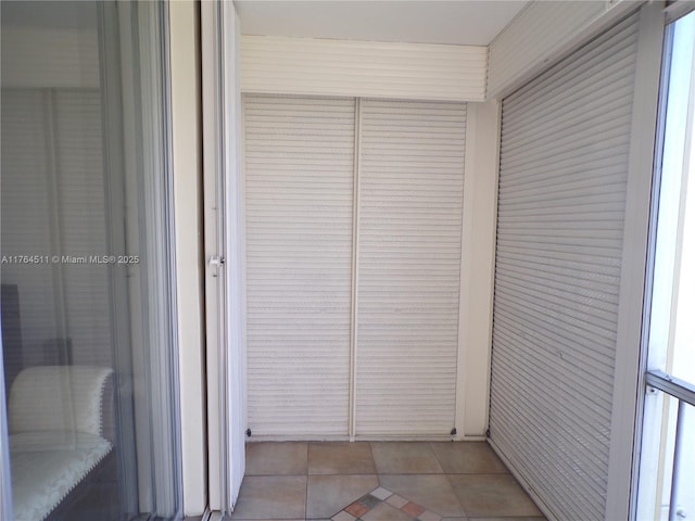 corridor featuring light tile patterned floors