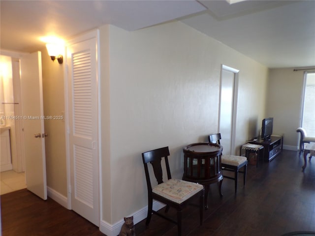 living area featuring wood finished floors and baseboards