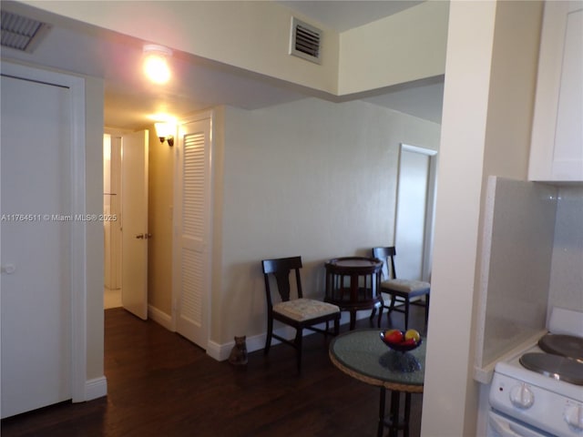 interior space featuring dark wood finished floors, visible vents, and baseboards