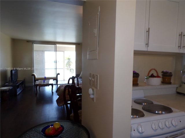 kitchen featuring white cabinetry, wood finished floors, electric panel, and white electric range