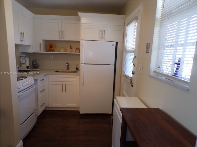 kitchen featuring white appliances, a sink, light countertops, white cabinets, and dark wood-type flooring