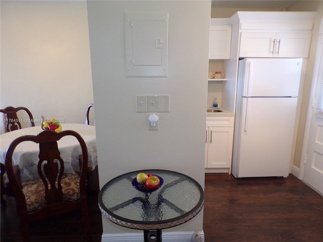 dining area with electric panel and dark wood-style floors