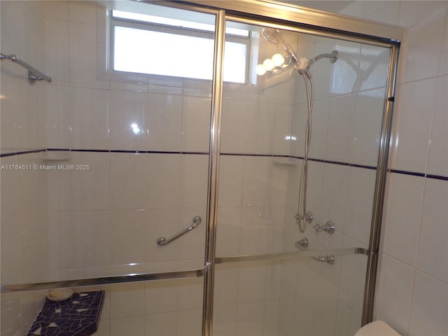 full bath with a tile shower