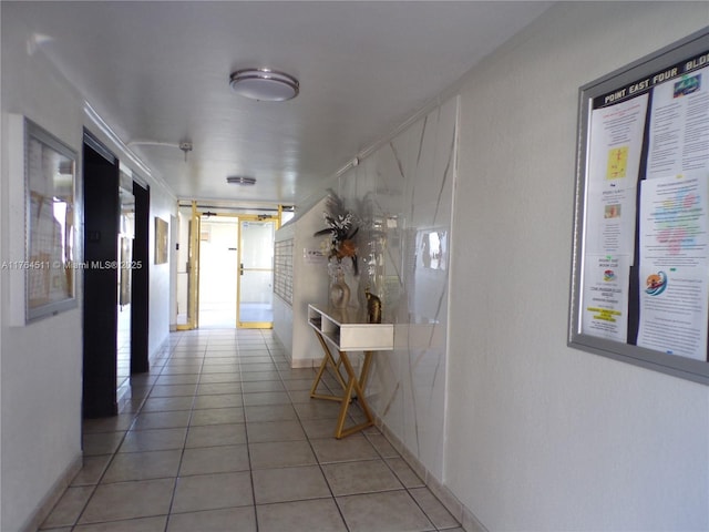 hall featuring light tile patterned flooring