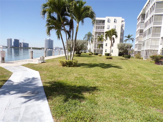 surrounding community featuring a yard and a water view