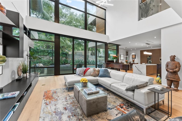 2803 Crystal Ct, Coconut Grove, FL 33133 - living area with a towering ceiling, light wood-type flooring, and healthy amount of natural light