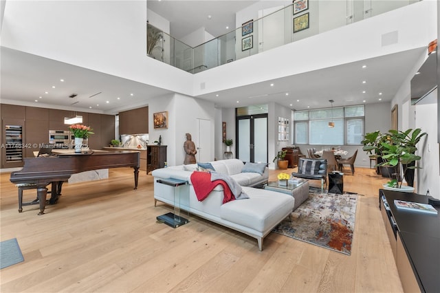 2803 Crystal Ct, Coconut Grove, FL 33133 - living room with light wood-style flooring, a high ceiling, recessed lighting, and wine cooler