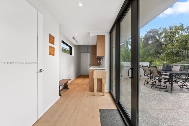 2803 Crystal Ct, Coconut Grove, FL 33133 - corridor with a sink, recessed lighting, light wood finished floors, and baseboards