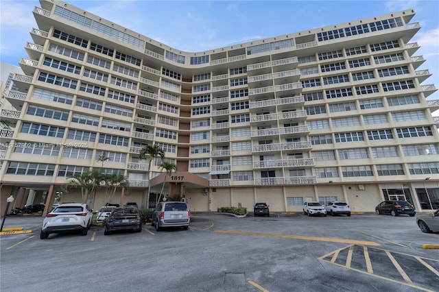 view of building exterior with uncovered parking