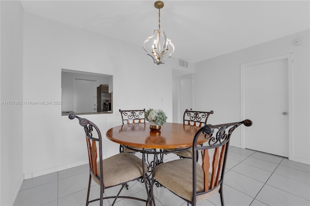 dining room featuring an inviting chandelier, light tile patterned floors, baseboards, and visible vents