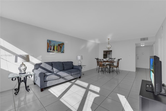 living room featuring light tile patterned floors and visible vents