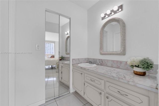 ensuite bathroom with ensuite bath, vanity, and tile patterned flooring