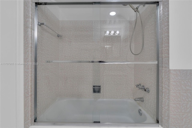 bathroom featuring shower / bath combination with glass door