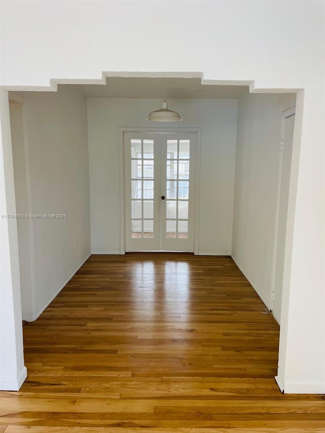 unfurnished room with french doors and light wood finished floors