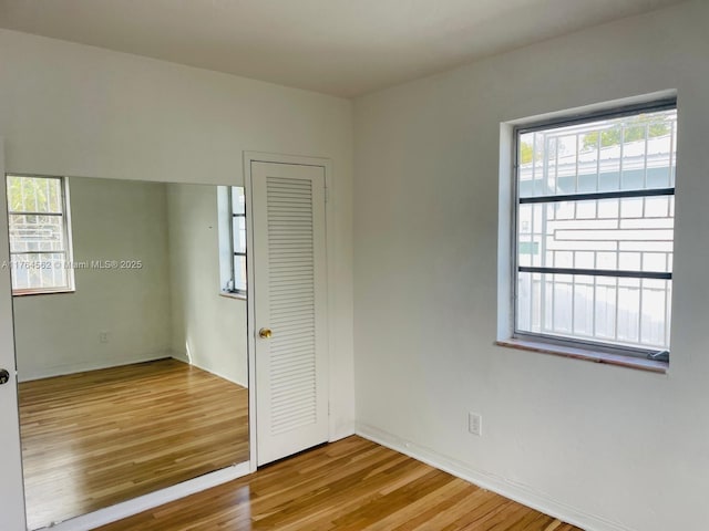 unfurnished bedroom featuring a closet and wood finished floors