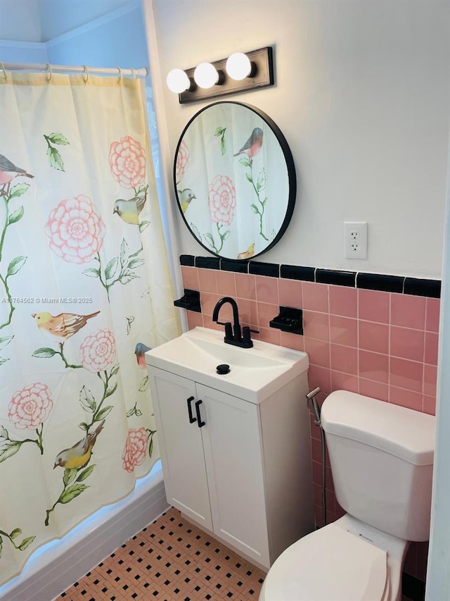 full bathroom featuring vanity, tile walls, and toilet