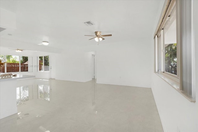 empty room with visible vents and ceiling fan