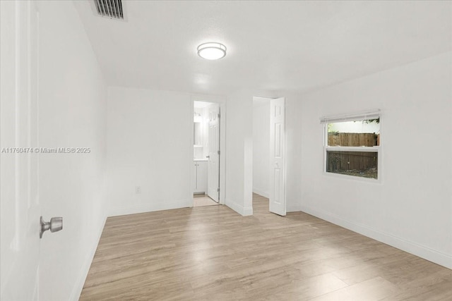 spare room with visible vents, baseboards, and light wood-style floors