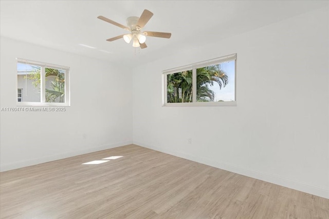 empty room with baseboards, light wood-style floors, and a ceiling fan