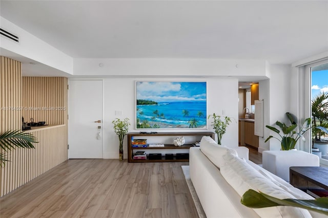 living area featuring wood finished floors and visible vents