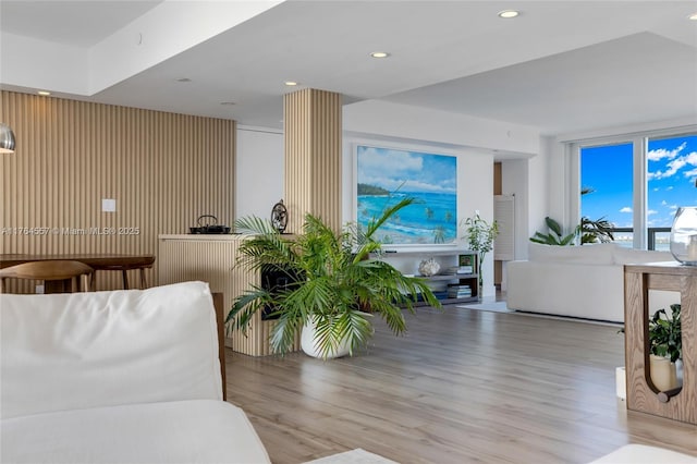 living area with recessed lighting and wood finished floors