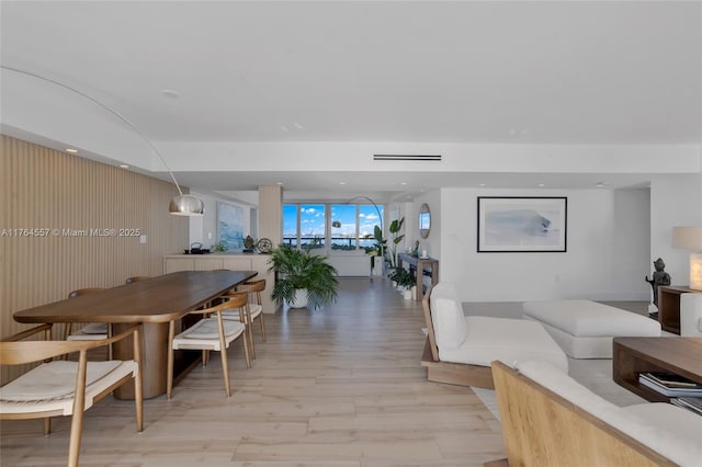 living area with recessed lighting and light wood-style floors