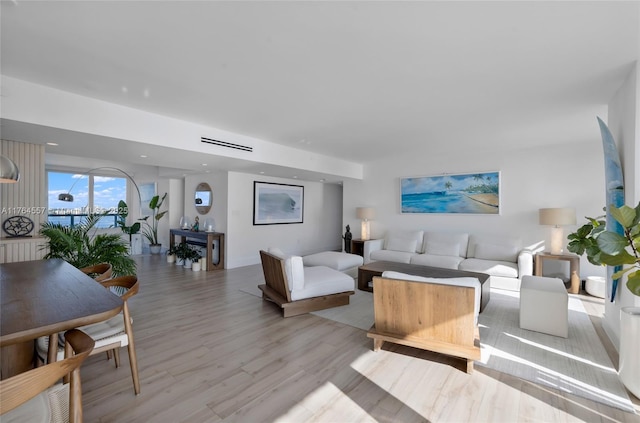 living room with recessed lighting, visible vents, and light wood-style flooring