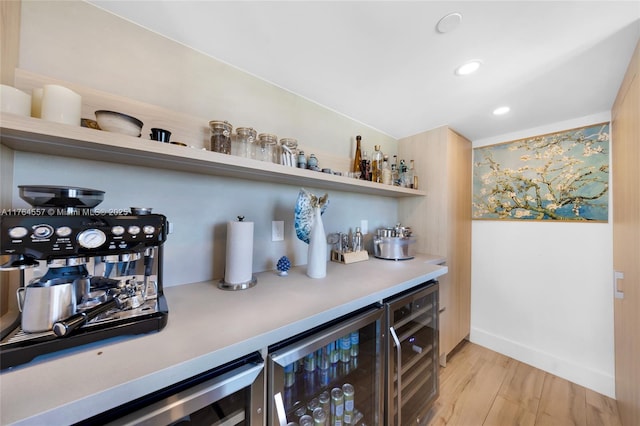 bar with a bar, wine cooler, baseboards, and light wood-type flooring