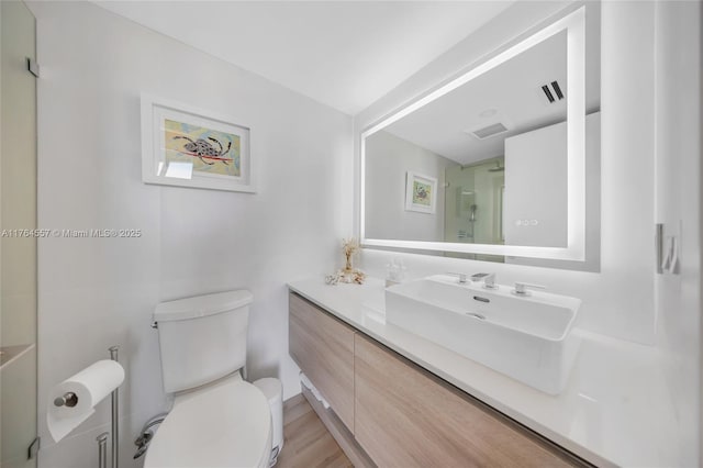 bathroom with visible vents, toilet, and vanity