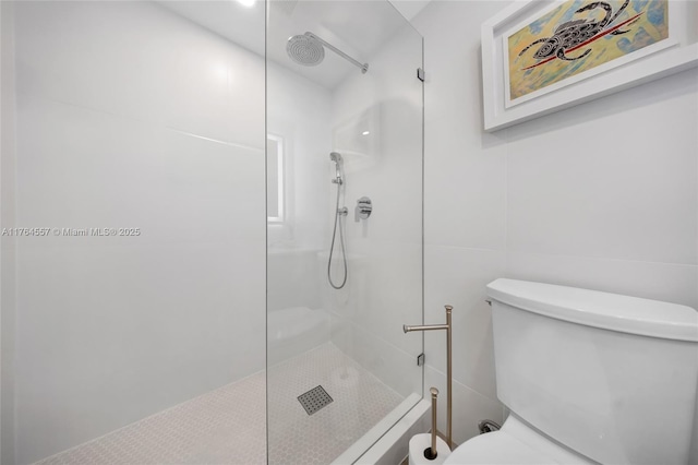 full bath featuring tile walls, toilet, and a walk in shower