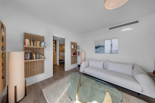 living room featuring wood finished floors and baseboards