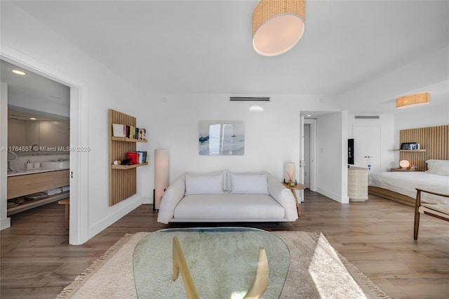 living area featuring baseboards and wood finished floors