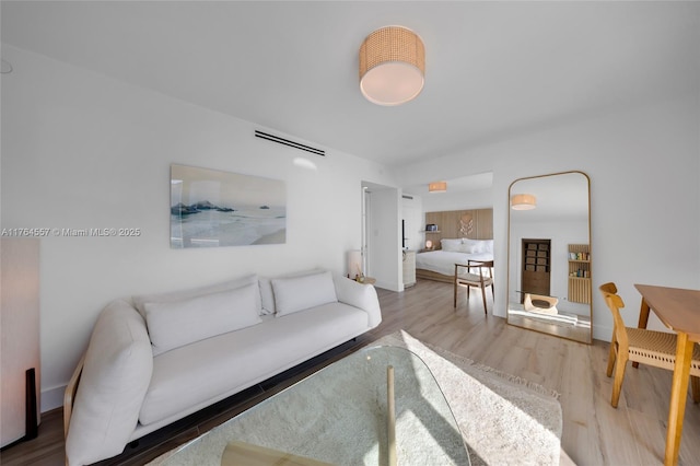 living room with visible vents and wood finished floors